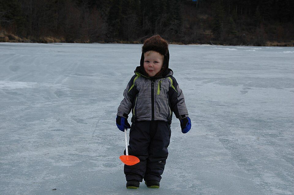 ice fishing on a frozen canal
